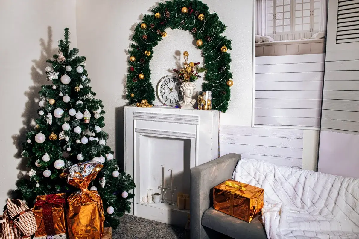 A cozy living room with Christmas trees, gifts, and festive decorations.