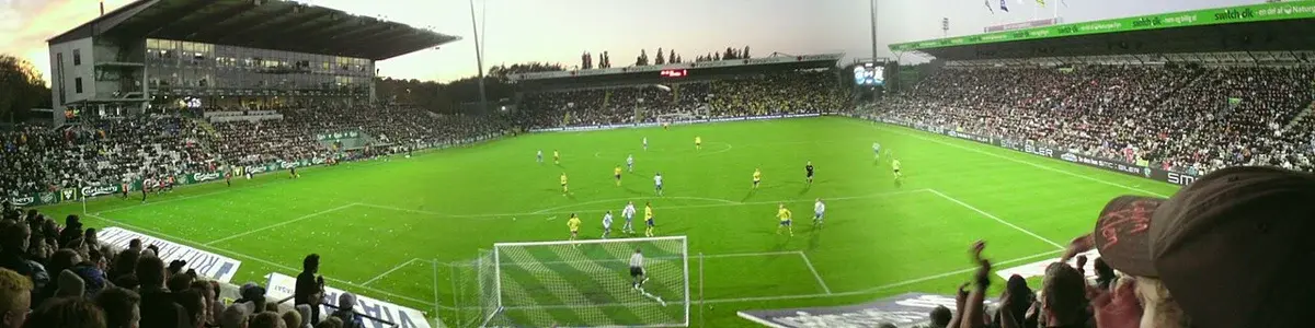 Panoramic view of a crowded soccer stadium during a match.