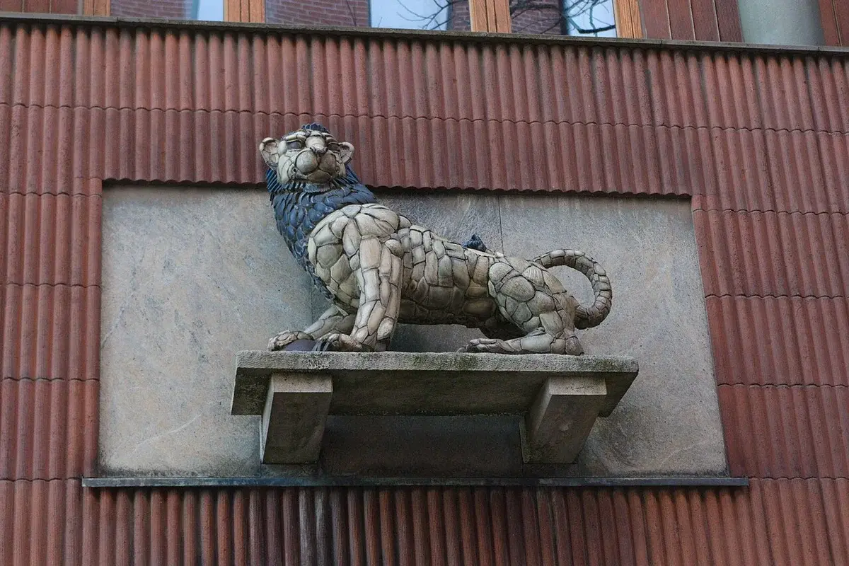A lion sculpture on the facade of a building.