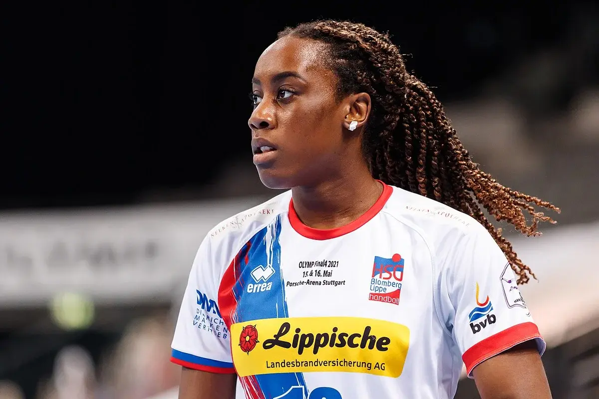 A handball player in a white HSG Blomberg-Lippe jersey during a match.