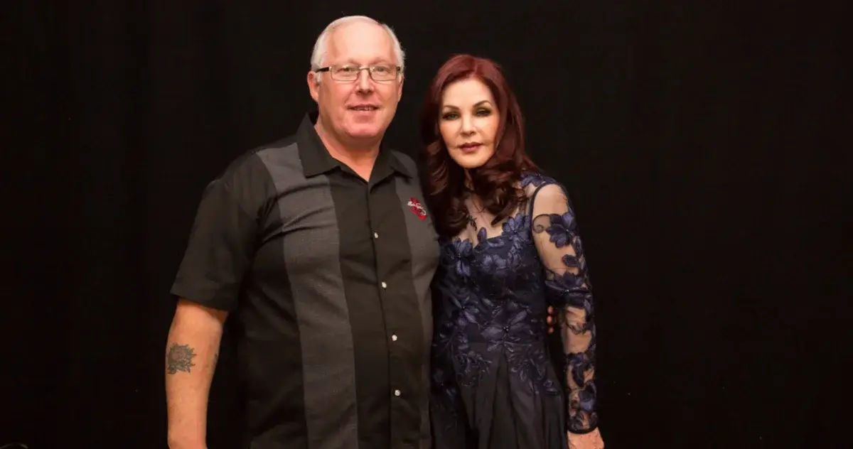 Priscilla Presley posing with a man at a meet-and-greet event.